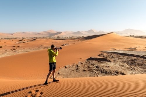 Red sand dunes of the Namib, a photographer in the foreground
